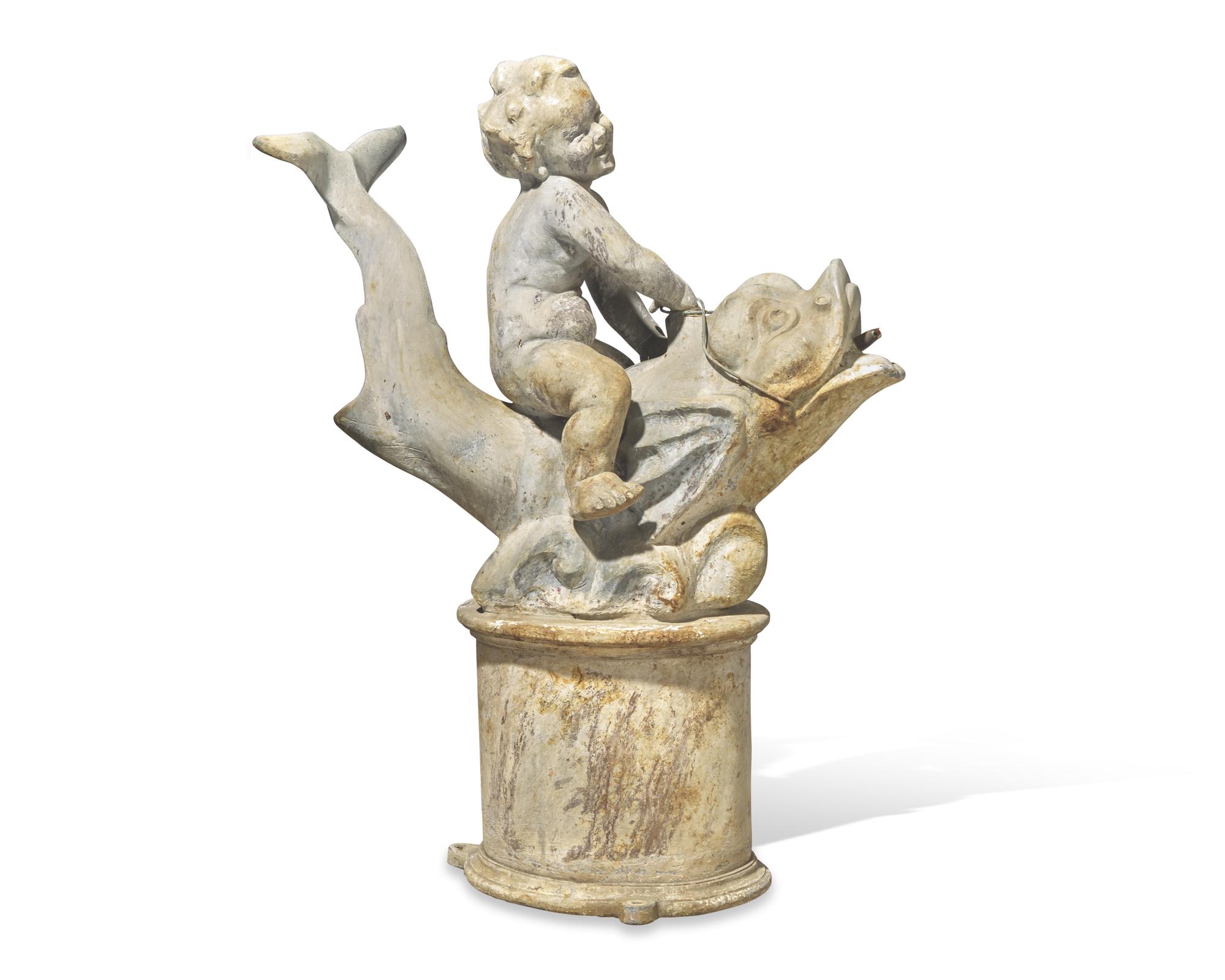 A lead or zinc fountain head in the form of a putto riding a dolphin, 19th / 20th century