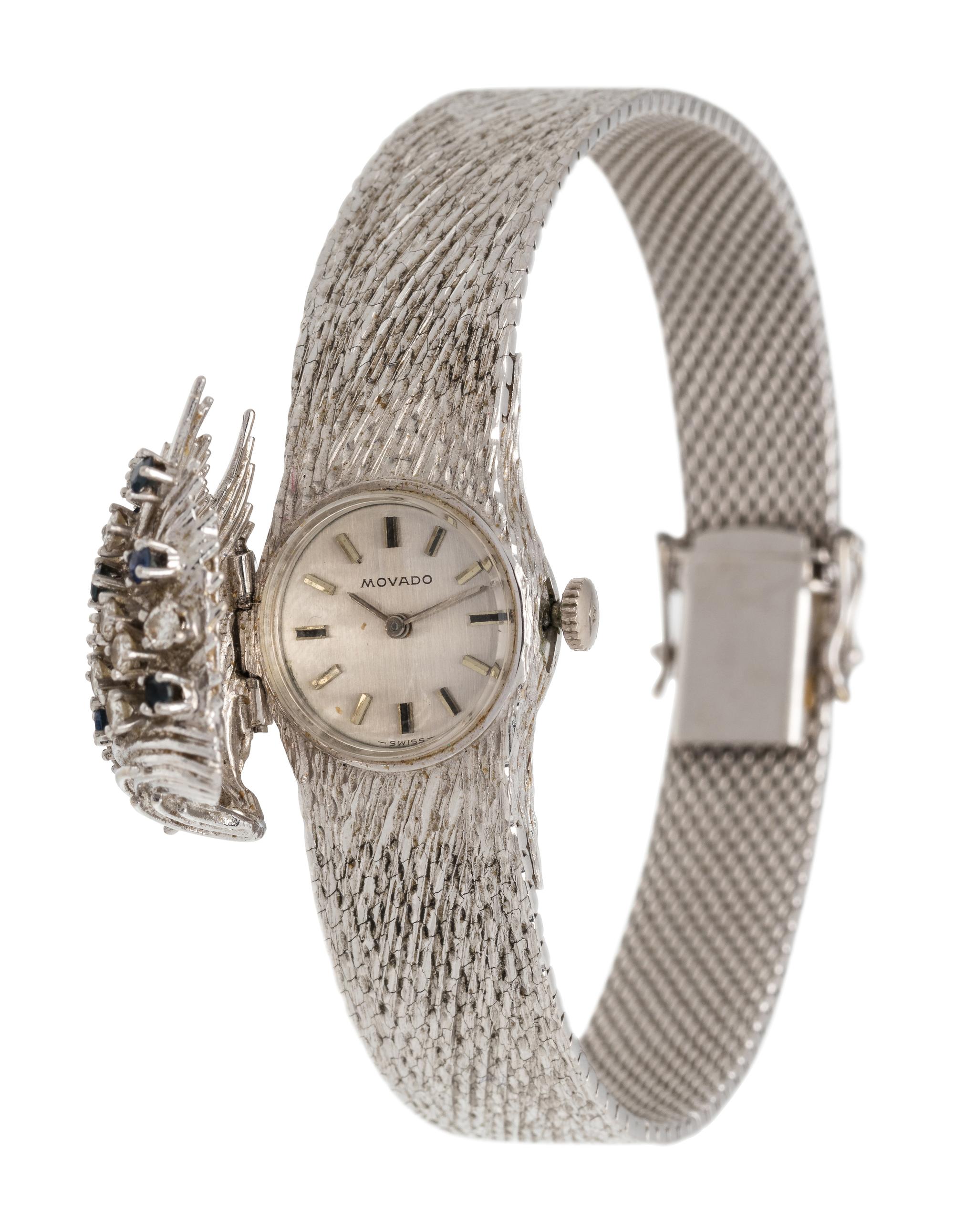 MOVADO, 18K WHITE GOLD, DIAMOND AND SAPPHIRE SURPRISE WRISTWATCH