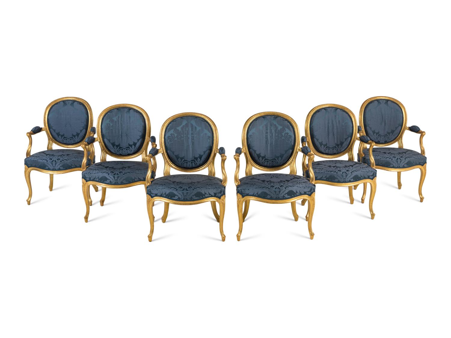 A Set of Six George III Carved Giltwood Armchairs