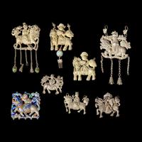 Eight Chinese Silver 'Boy and Qilin' Pendants, Late Qing Dynasty-Republic Period 晚清-民國 銀鍍金、銀燒藍及銀製麒麟送子長命鎖一組八件