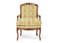 A Louis XV Style Carved Fruitwood Fauteuil