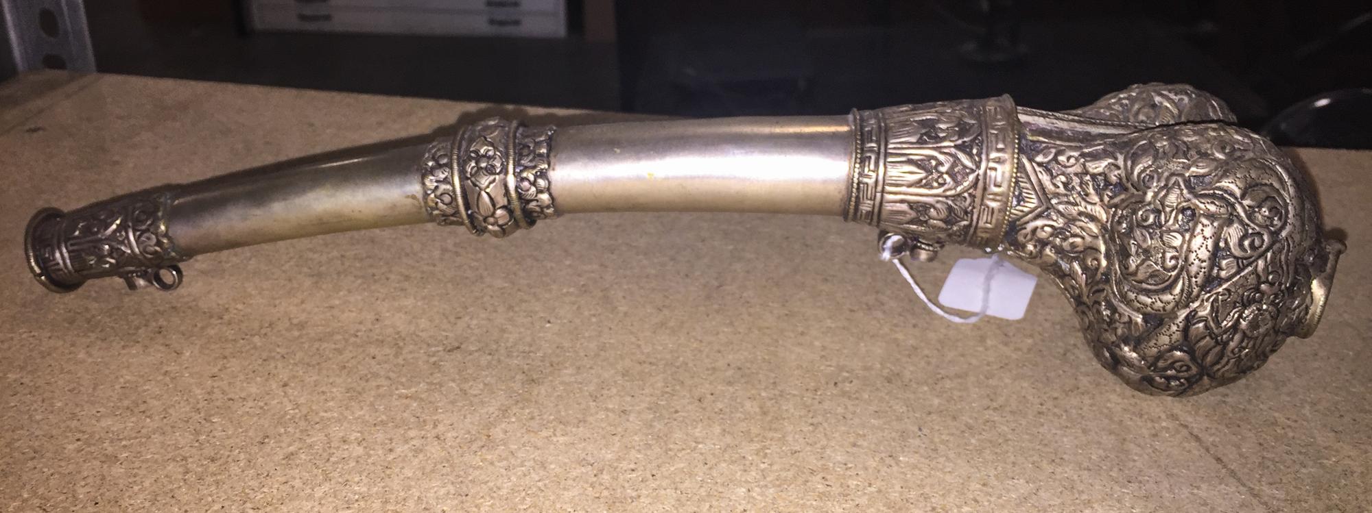 A Tibetan Silvered Metal Horn. Length 14 3/4 inches.