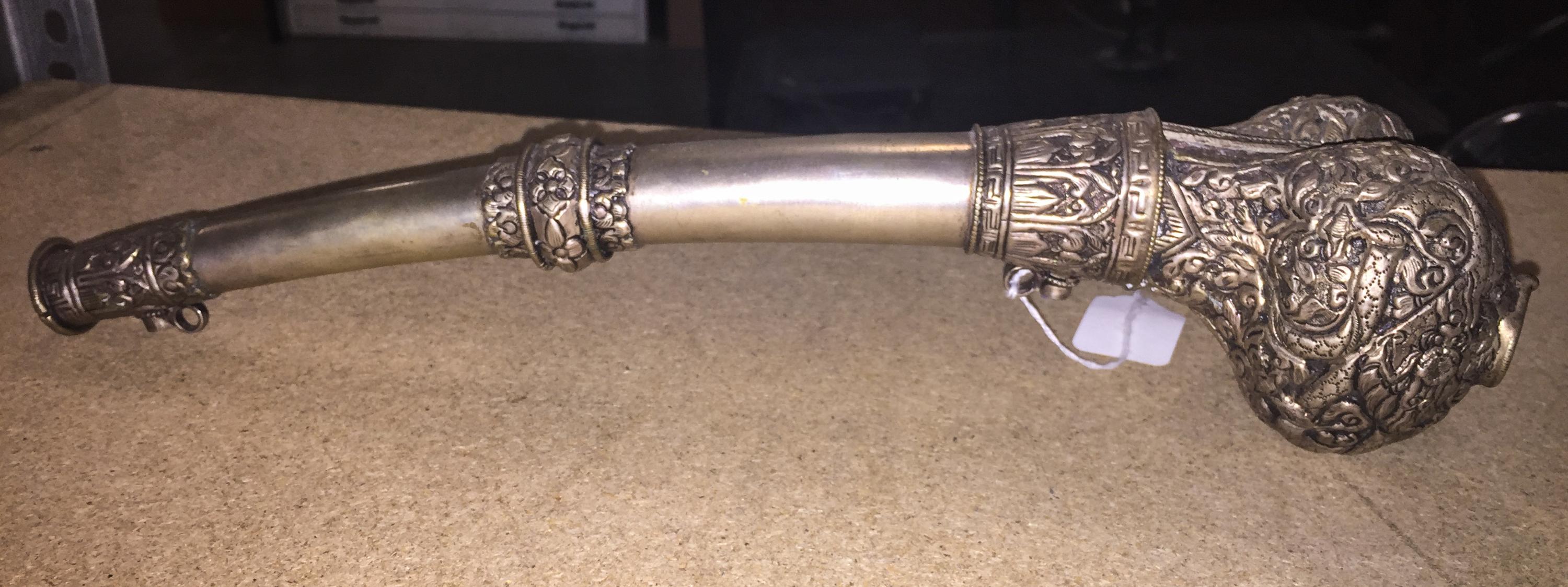A Tibetan Silvered Metal Horn. Length 14 3/4 inches.