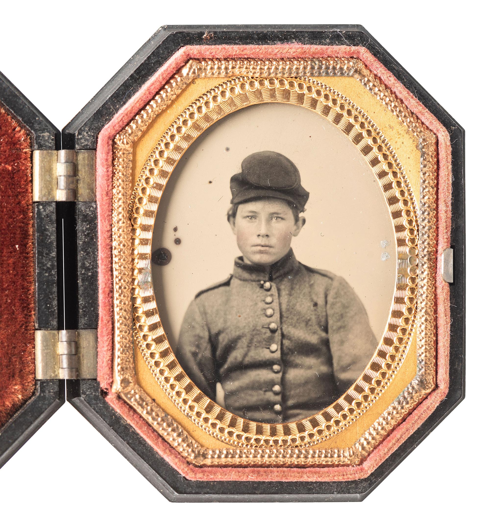 [CIVIL WAR]. Ninth plate ambrotype portrait of a strikingly young soldier wearing shell jacket and forage cap.