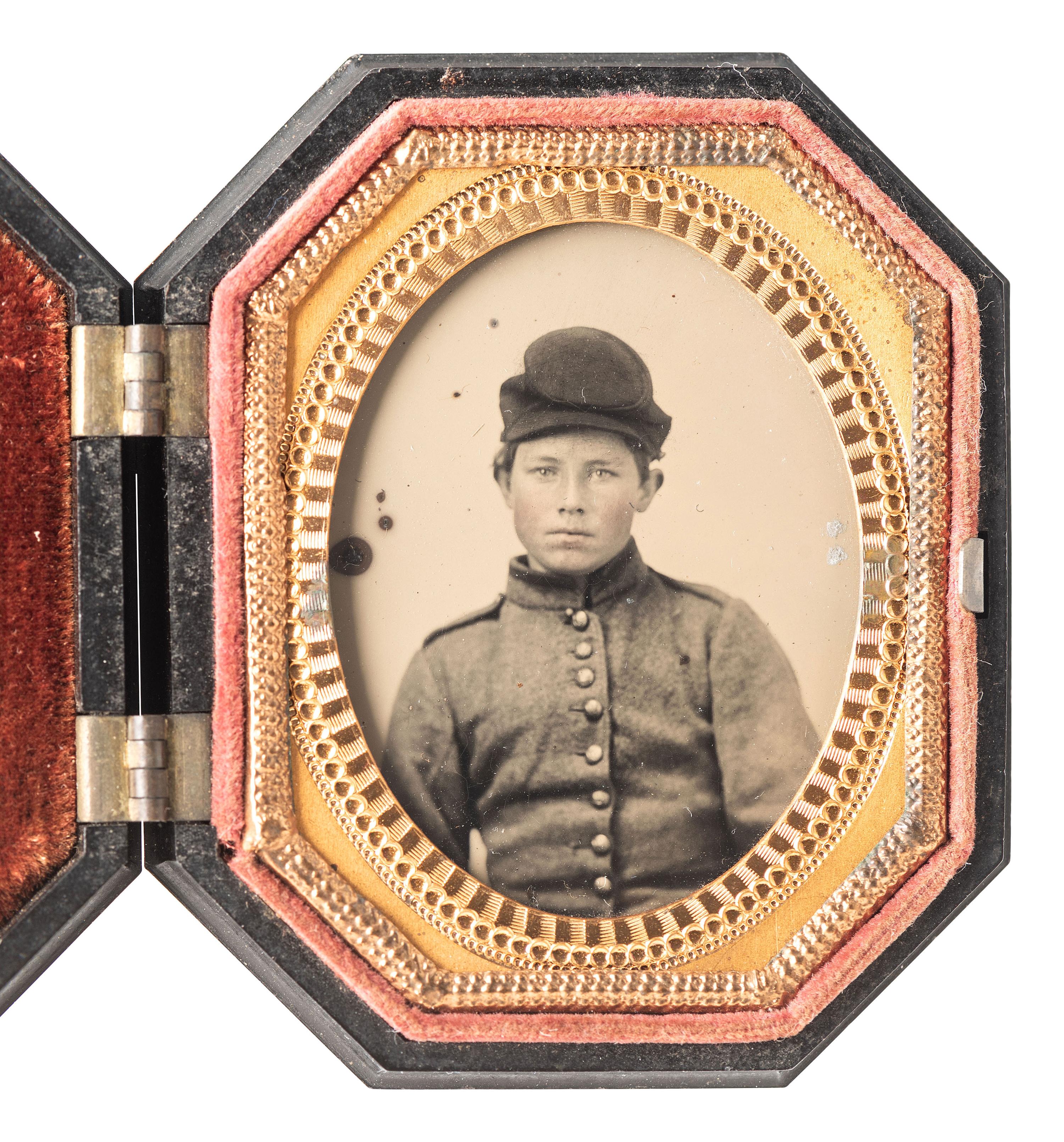 [CIVIL WAR]. Ninth plate ambrotype portrait of a strikingly young soldier wearing shell jacket and forage cap.