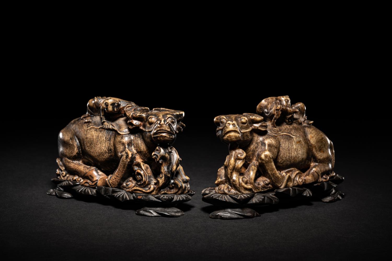 A Pair of Chinese Brown Hardstone 'Ox and Herd' Figural Groups