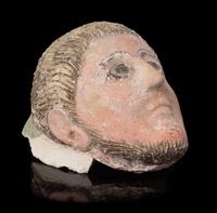 A Romano-Egyptian Plaster Mummy Mask Height 9 1/2 inches. — CIRCA 2ND CENTURY C.E.