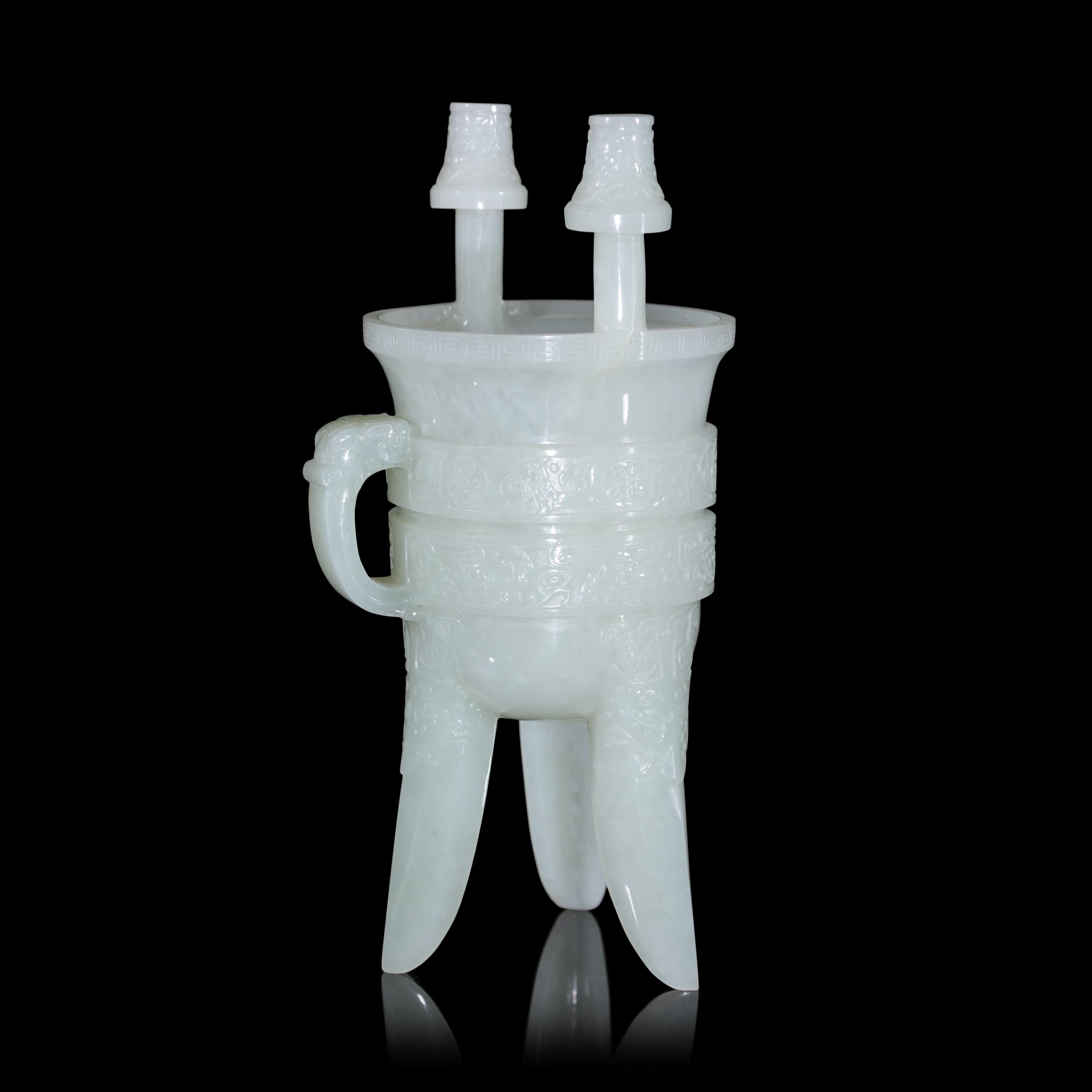A Chinese Carved Pale Celadon Jade Tripod Vessel, Jia, Late Qing - Early Republic Period 晚清/民國 青白玉仿古斝