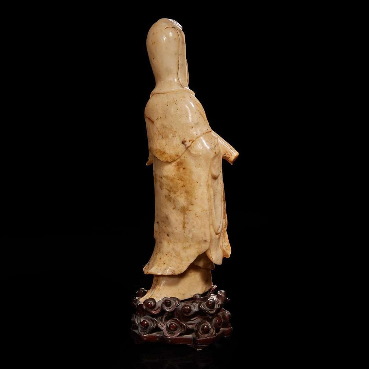 A Chinese carved beige soapstone figure of Guanyin and carved hardwood stand 壽山石雕觀音配木座 Late Qing dynasty/Republic period ?????