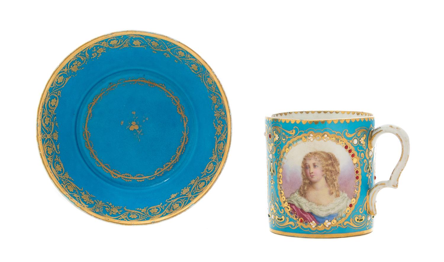A Sevres Jeweled Porcelain Cup Height of cup 2 7/8 inches, diameter of saucer 5 1/8 inches.