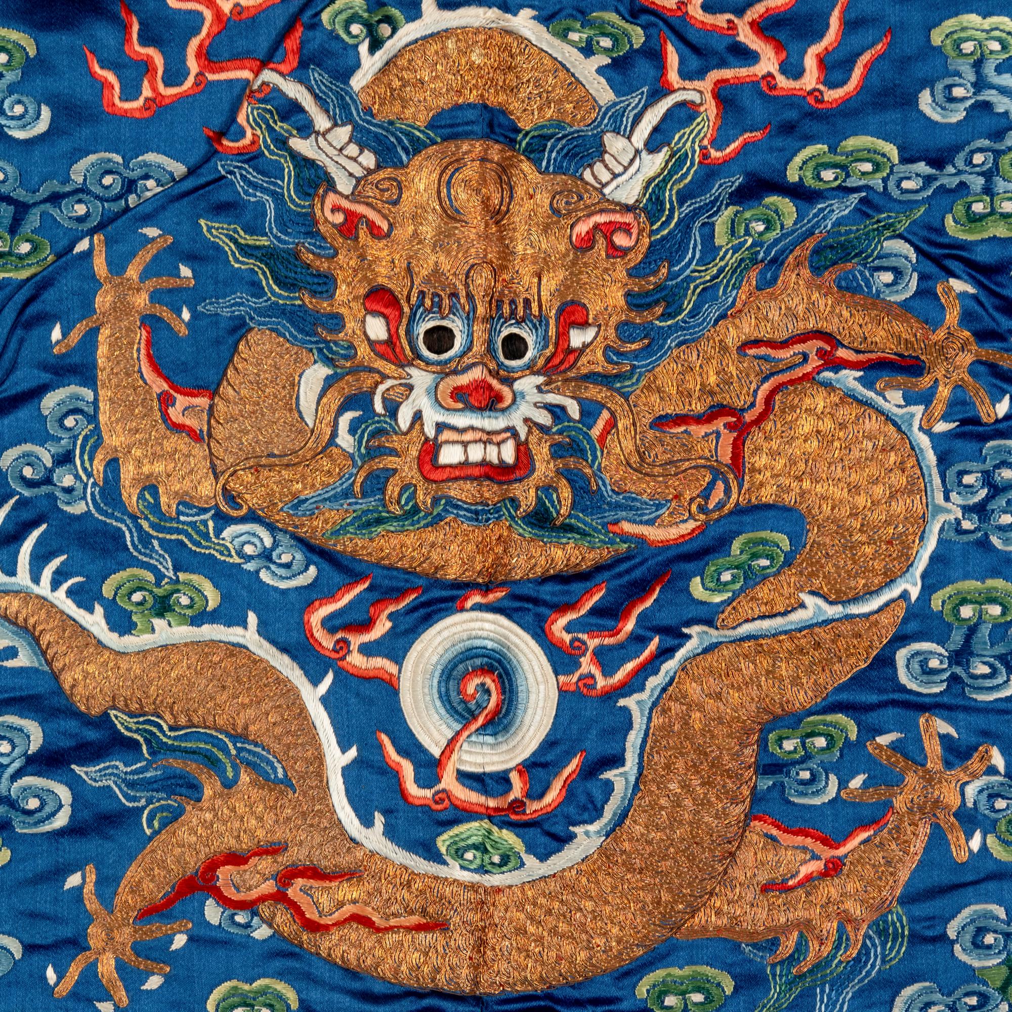 A Chinese Blue Ground Embroidered Silk 'Dragon' Robe, Jifu , 19th Century 清晚期 藍緞地綉云龍紋吉服