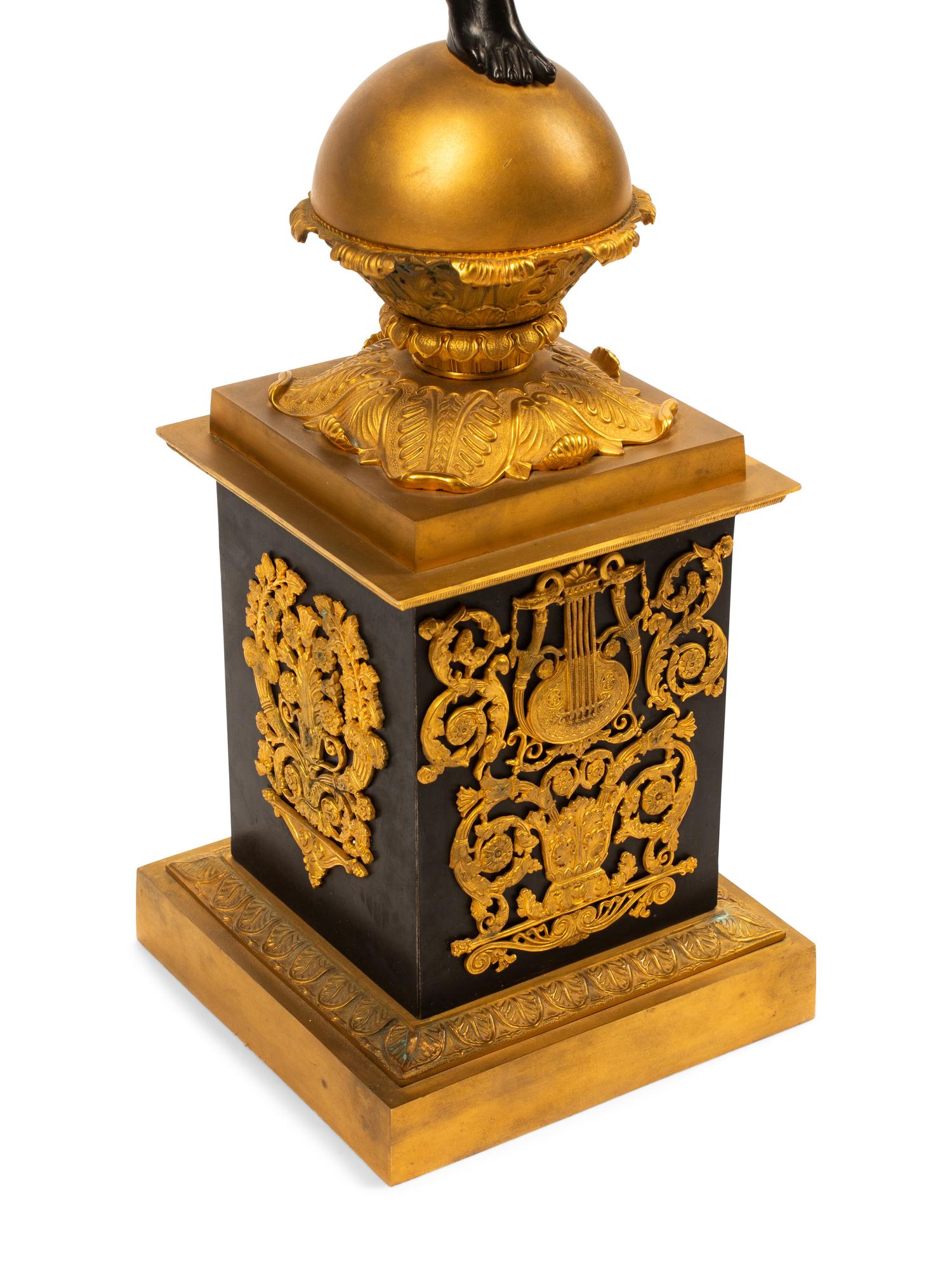 A Pair of Monumental Empire Style Gilt and Patinated Metal Seven-Light Figural Candelabra