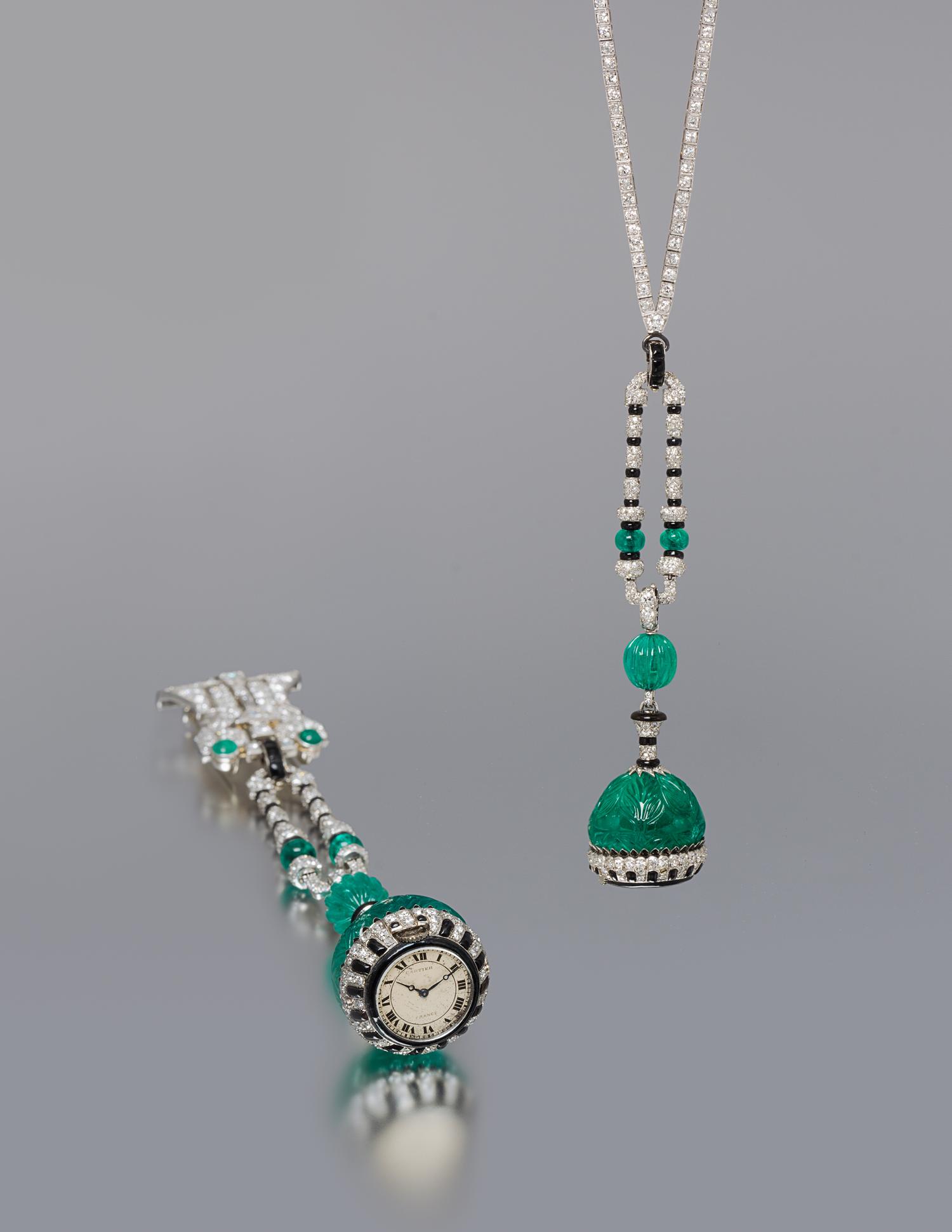 An Art Deco Platinum, Emerald, Diamond, Onyx and Enamel Lapel Watch, Cartier, 37.00 dwts.
