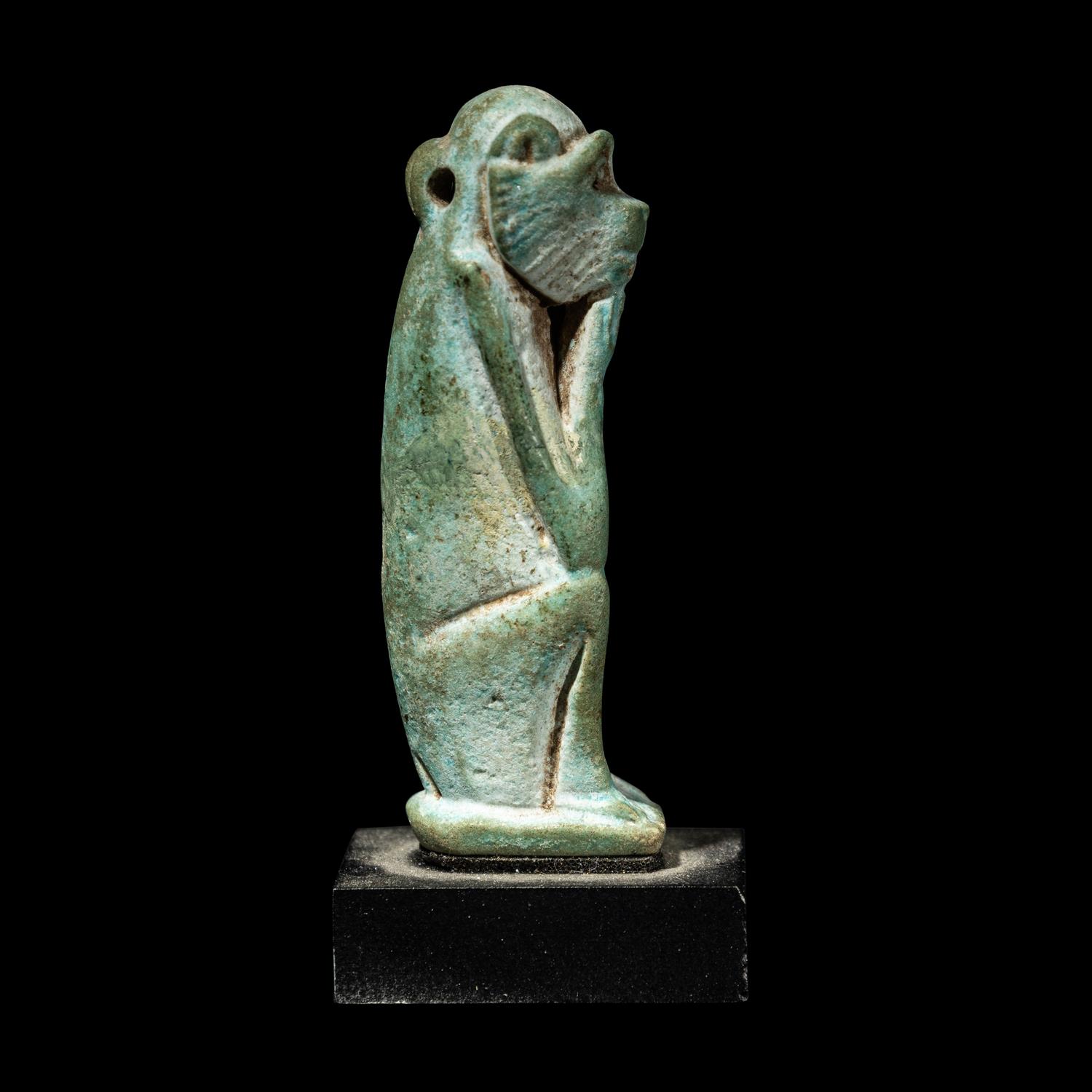 An Egyptian Faience Seated Monkey