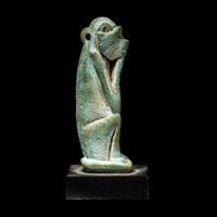 An Egyptian Faience Seated Monkey
