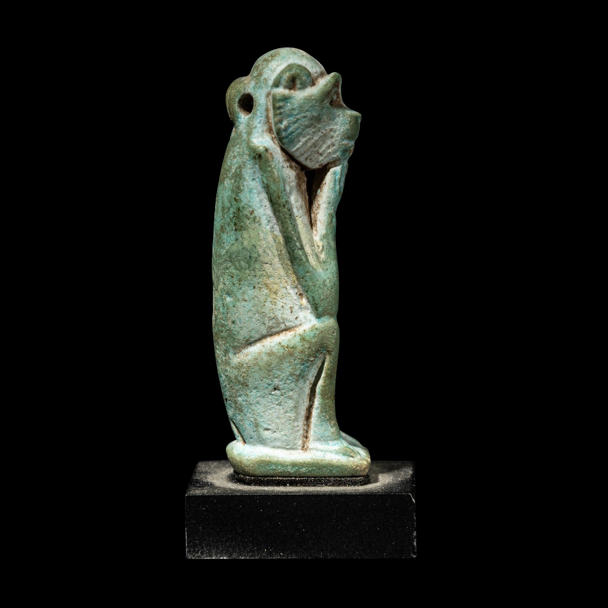 An Egyptian Faience Seated Monkey