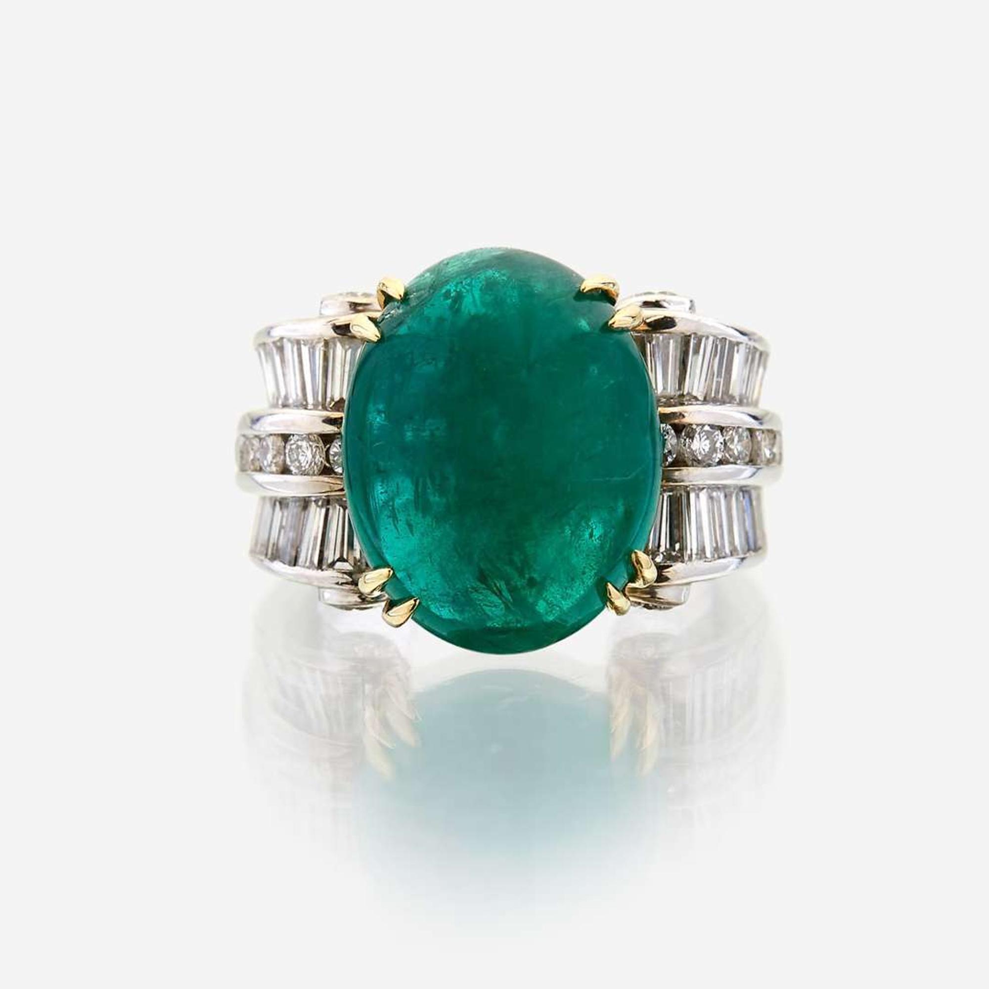 An emerald, diamond, and eighteen karat white gold ring
