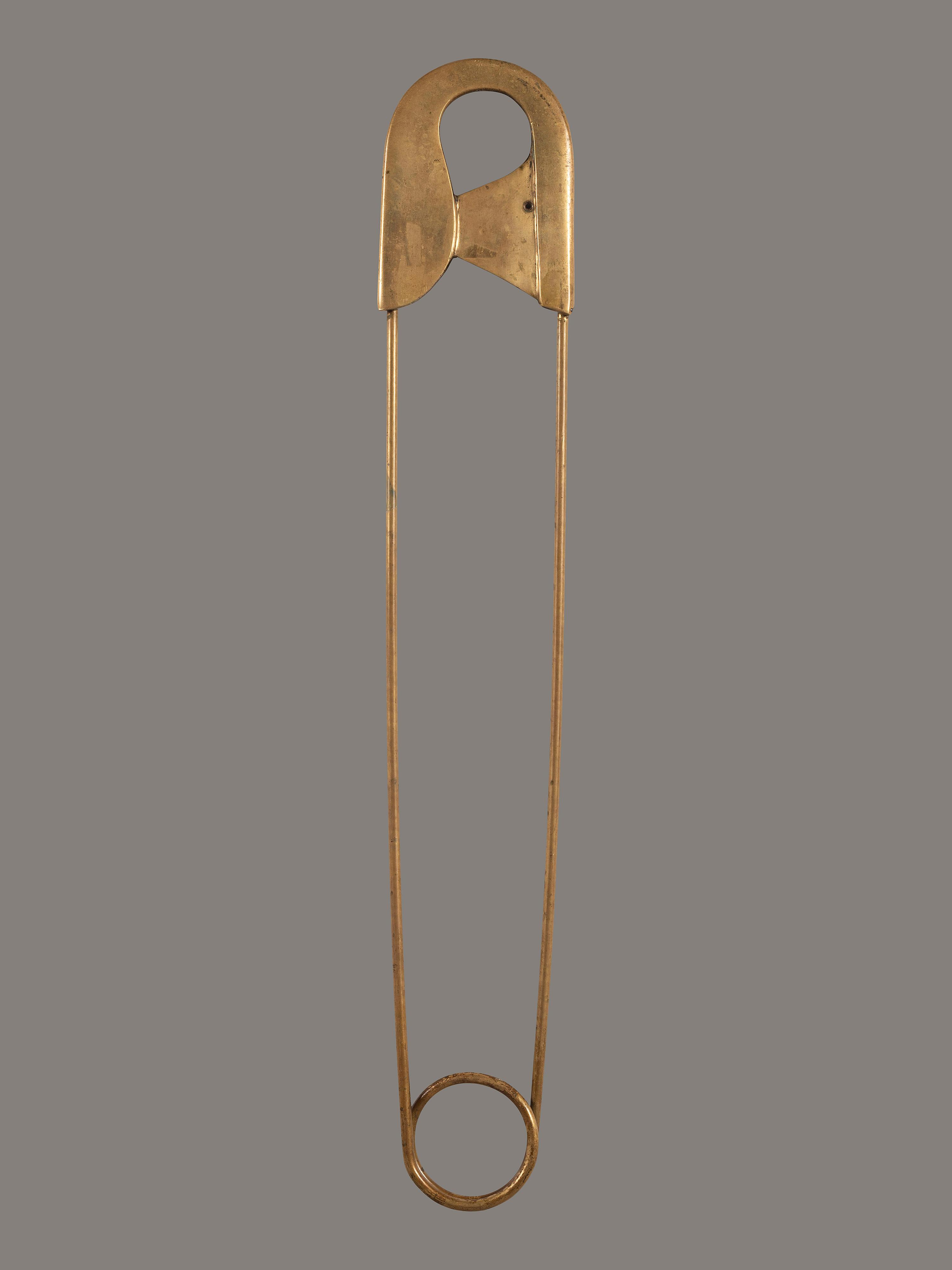 A Gold Painted Bronze Safety Pin Shop Sign