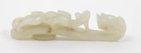 A Pale Celadon Jade Dragon Belt Hook. Length 3 7/8 inches.