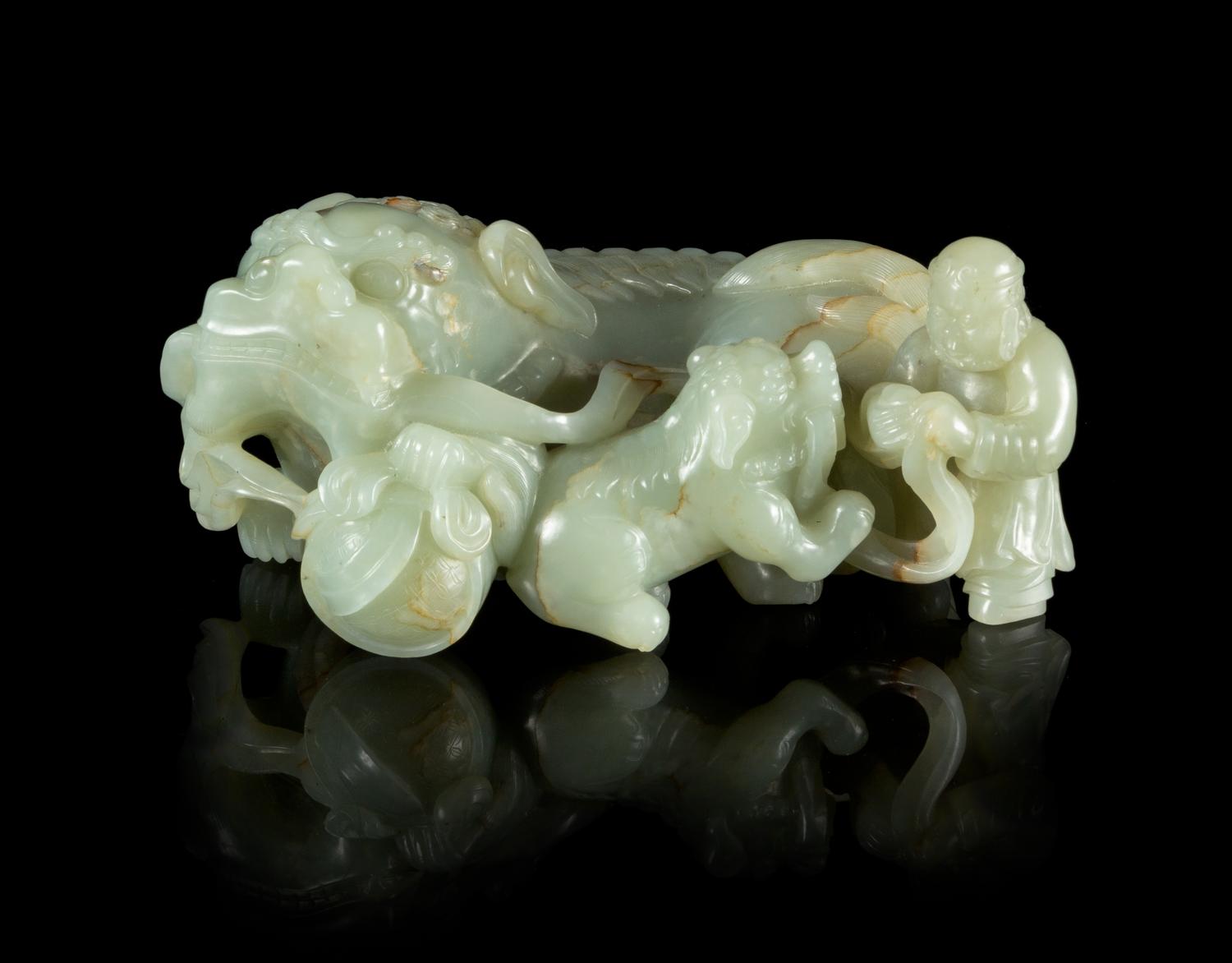 A Carved Celadon Jade Figural Group Length 7 1/2 inches.