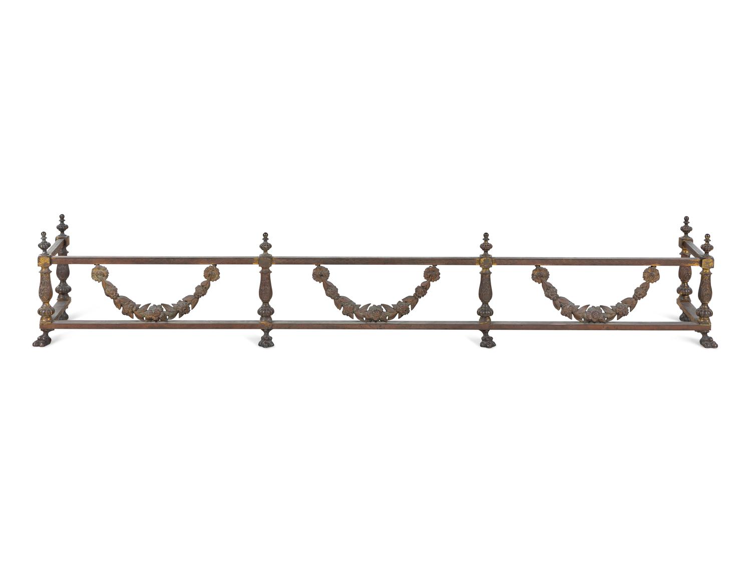 A Pair of Continental Brass and Iron Andirons and Fender
