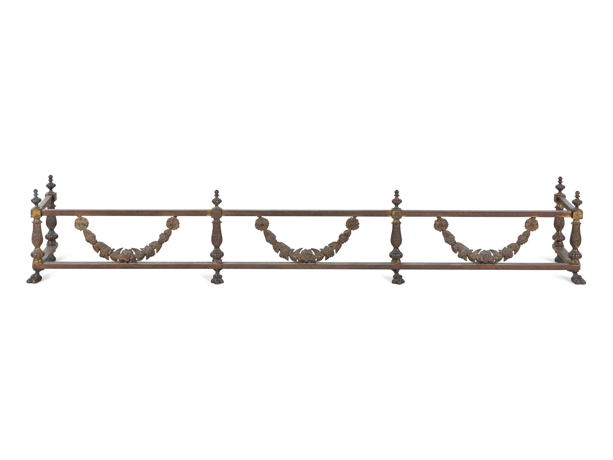 A Pair of Continental Brass and Iron Andirons and Fender