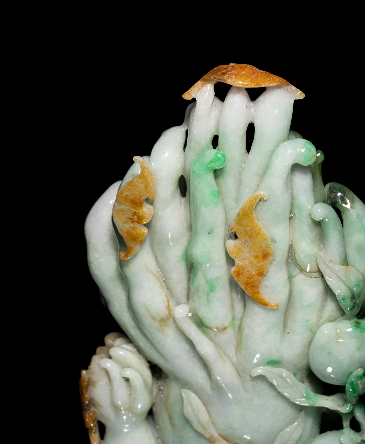 A Chinese Apple Green and Russet Jadeite Carving of Buddha's Hand Citron