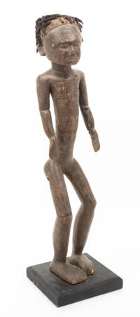 A Carved Ethnographic Figure Height 23 inches.