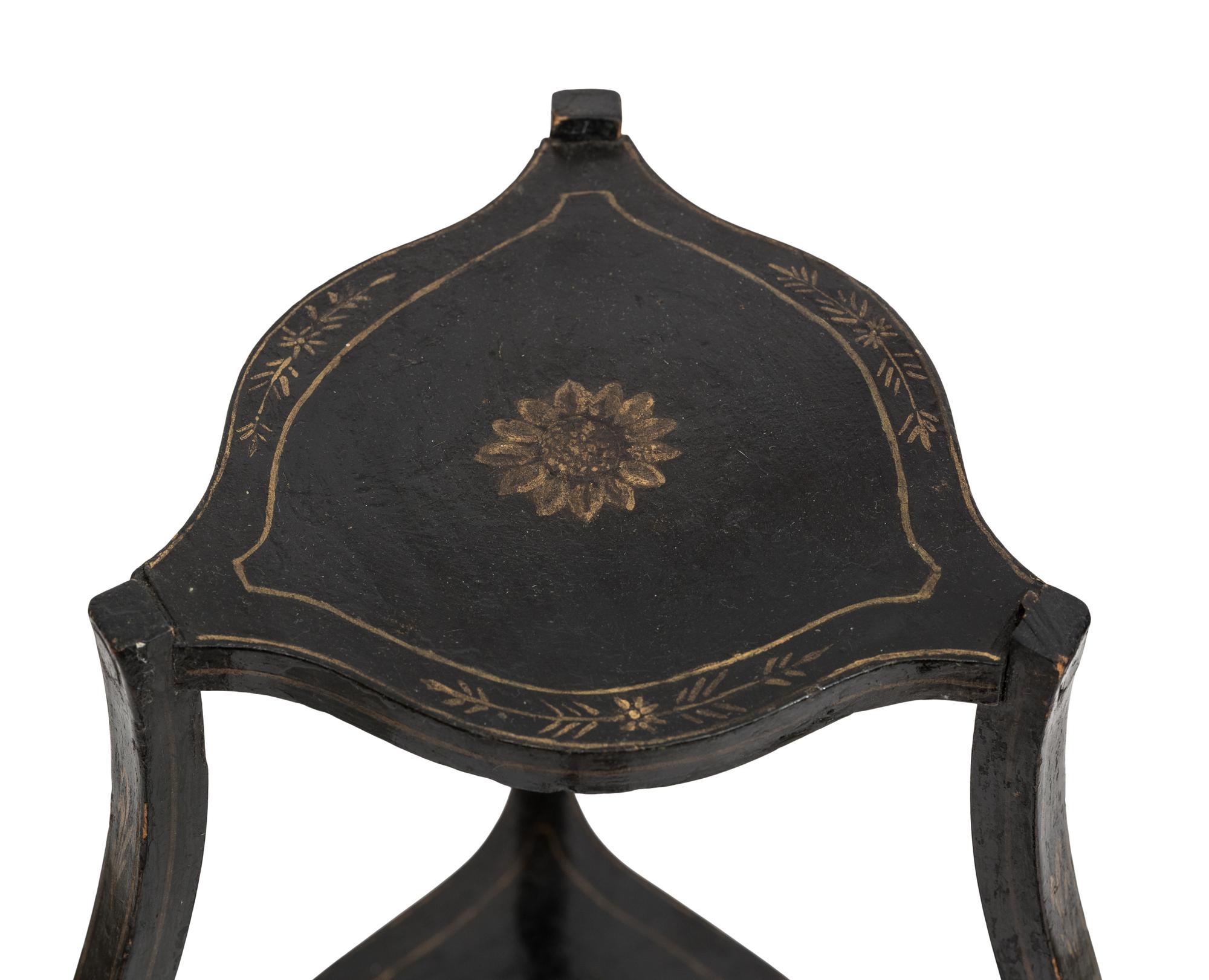 A Continental Style Black-Painted and Parcel Gilt Bombe Tripod Stand