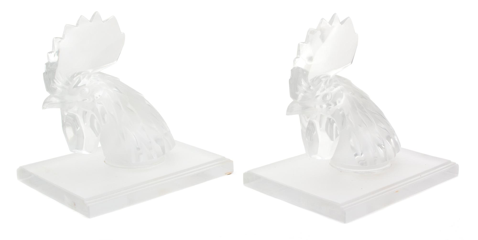 A Pair of Lalique Tete de Coq Molded and Frosted Glass Bookends Height 7 3/4 inches. — 20TH CENTURY