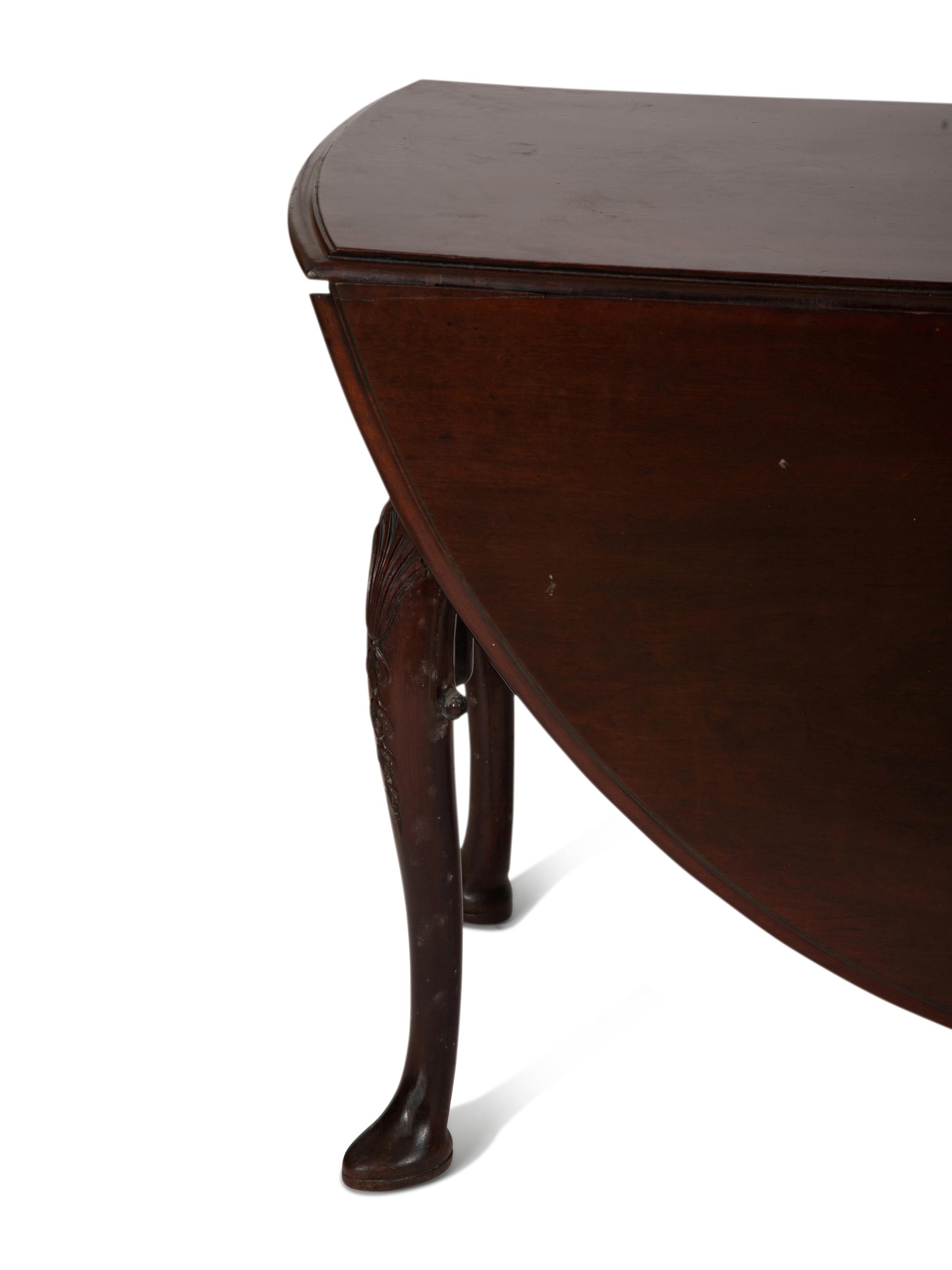 An Irish George II Style Carved Mahogany Drop Leaf Dining Table