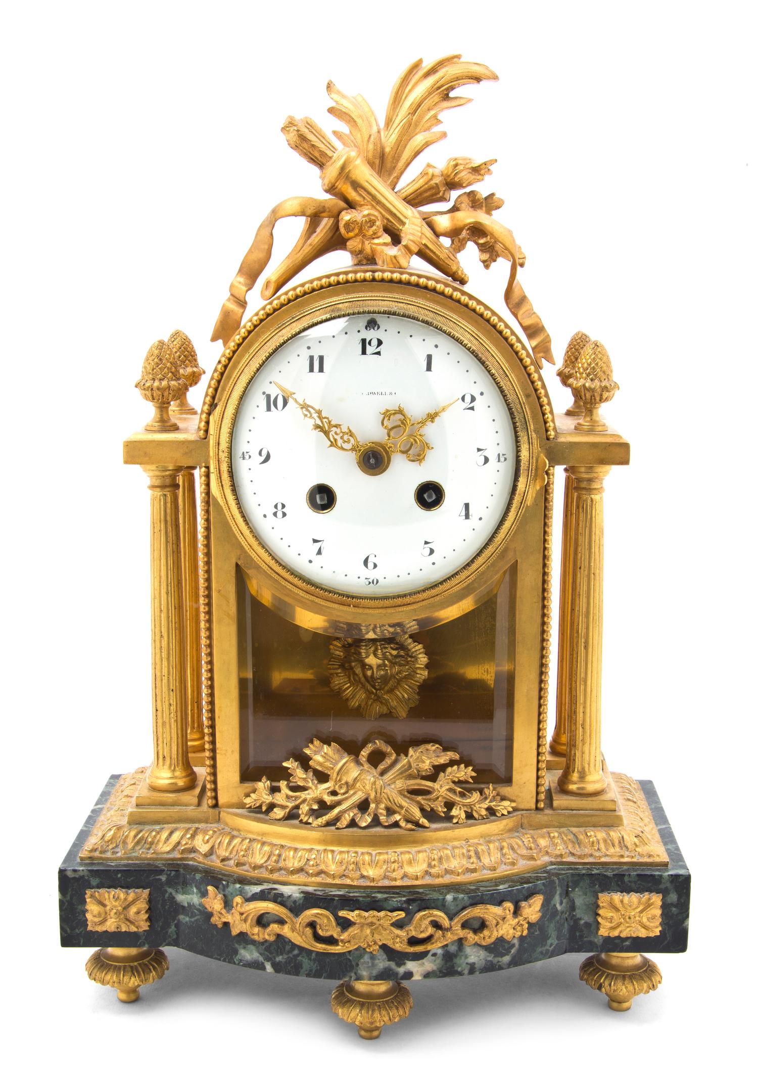 A French Gilt Bronze and Marble Mantel Clock, retailed by J.E. Caldwell & Co., Height 13 1/4 inches.
