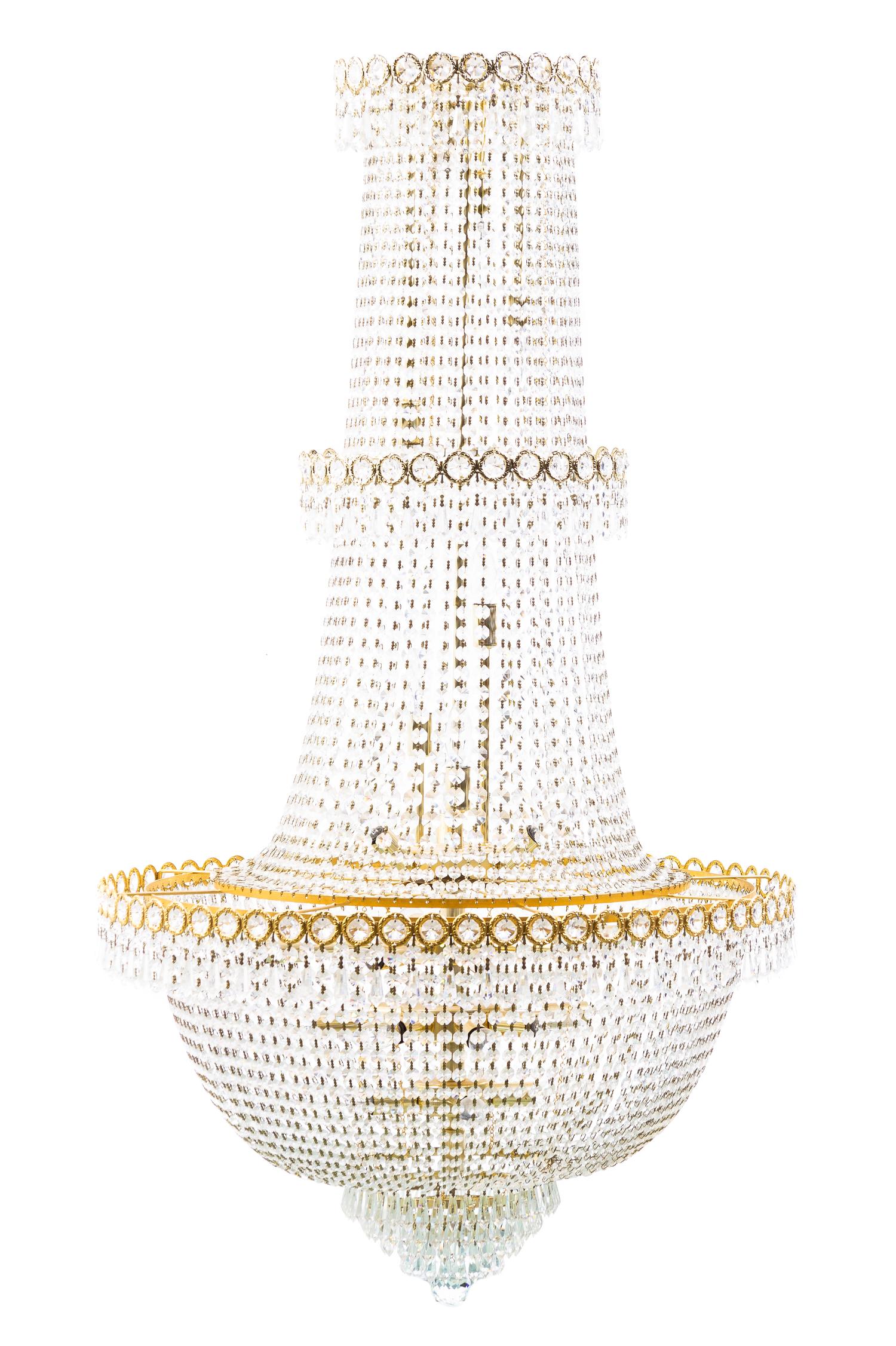 A Louis XVI Style Gilt Metal and Cut Glass Chandelier, Height 51 x diameter 27 1/2 inches.