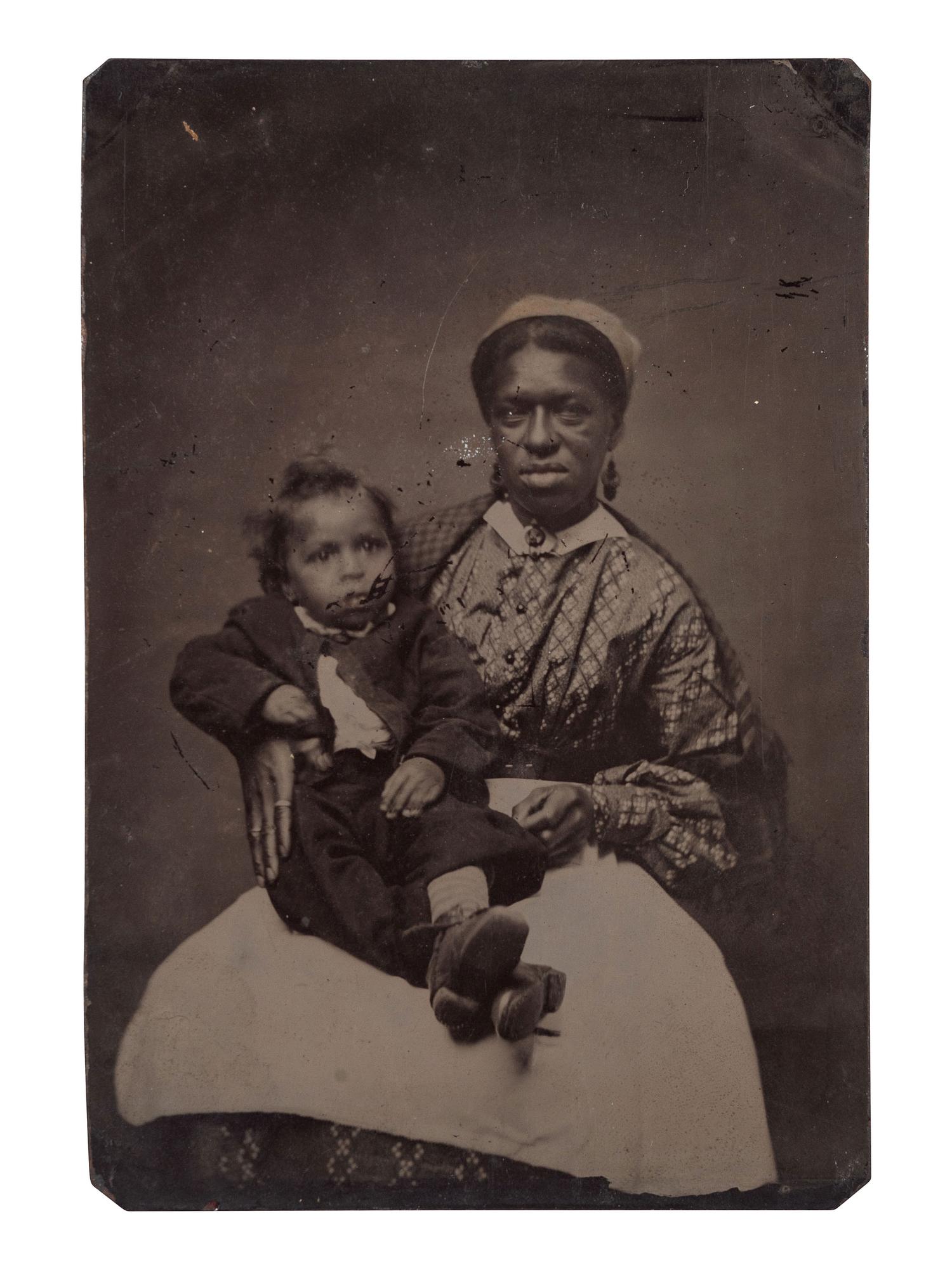 [EARLY PHOTOGRAPHY]. Tintype of African American mother and child.