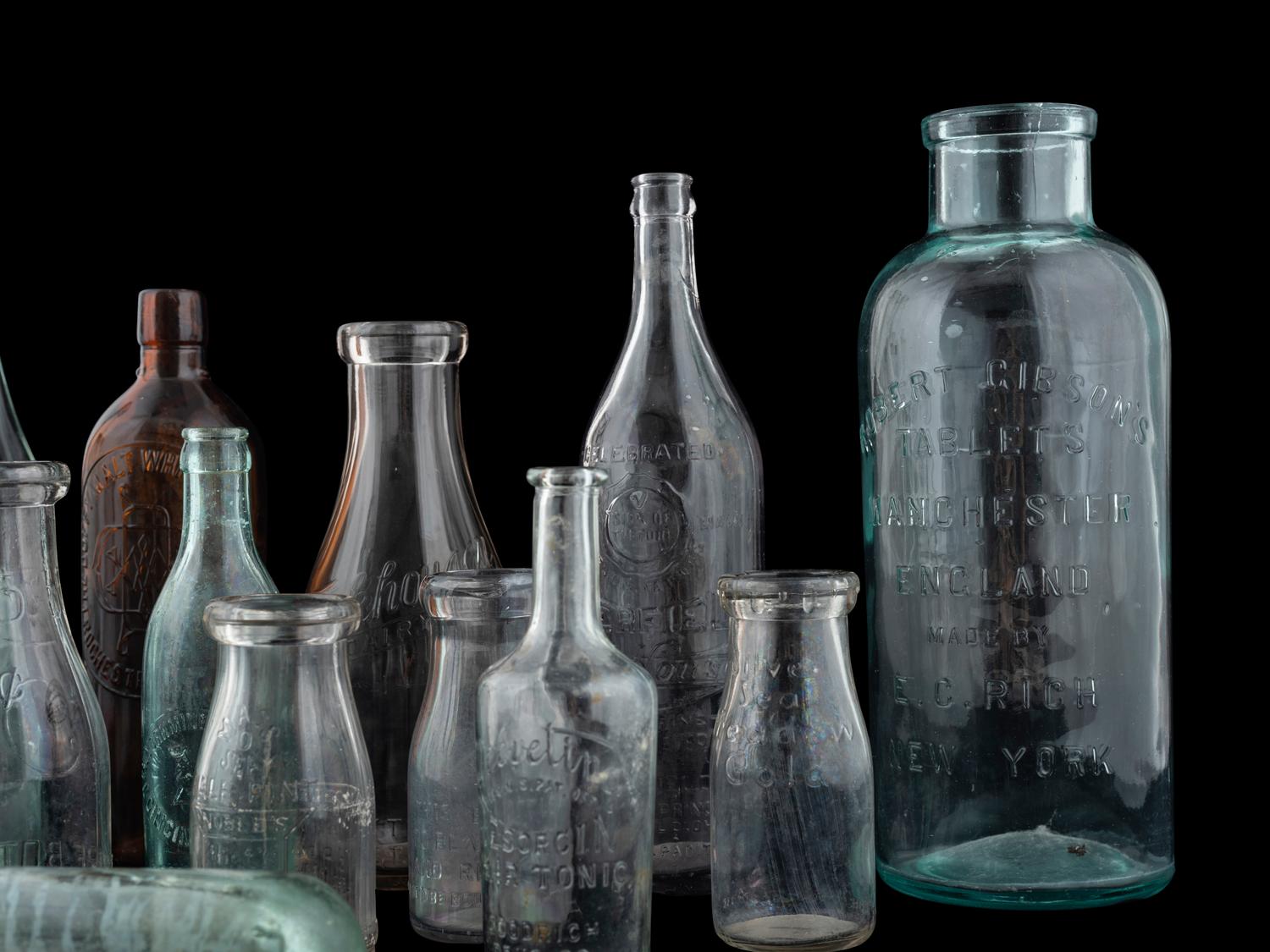 Sixteen Glass Advertising Bottles