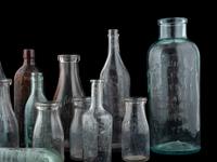 Sixteen Glass Advertising Bottles