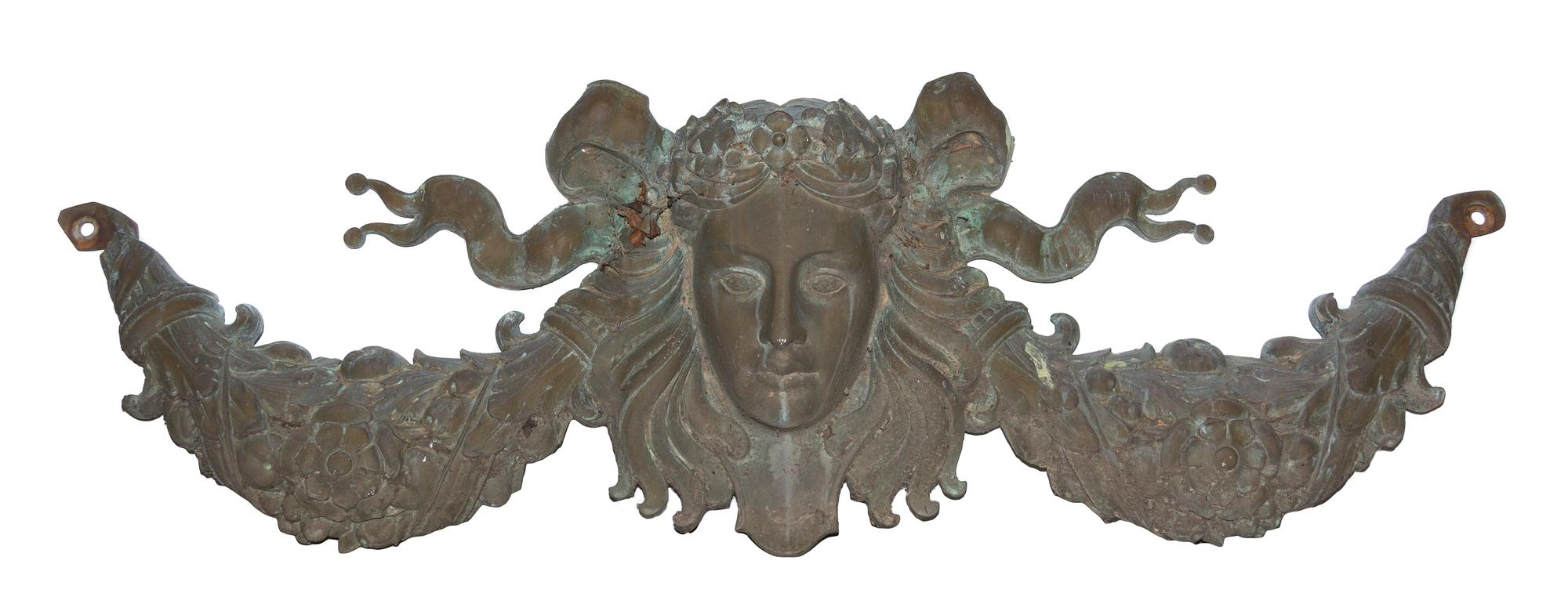 A Patinated Cast Metal Wall Applique Width 57 inches.