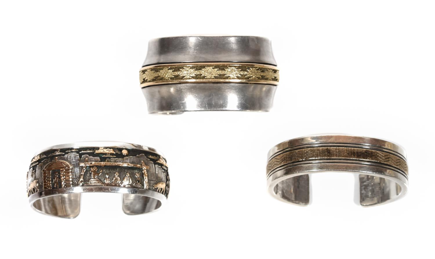 Three Southwestern Silver and 14 Karat Gold Cuff Bracelets Length of first 5 1/4 x opening 7/8 x width 5/8 inches