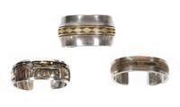 Three Southwestern Silver and 14 Karat Gold Cuff Bracelets Length of first 5 1/4 x opening 7/8 x width 5/8 inches
