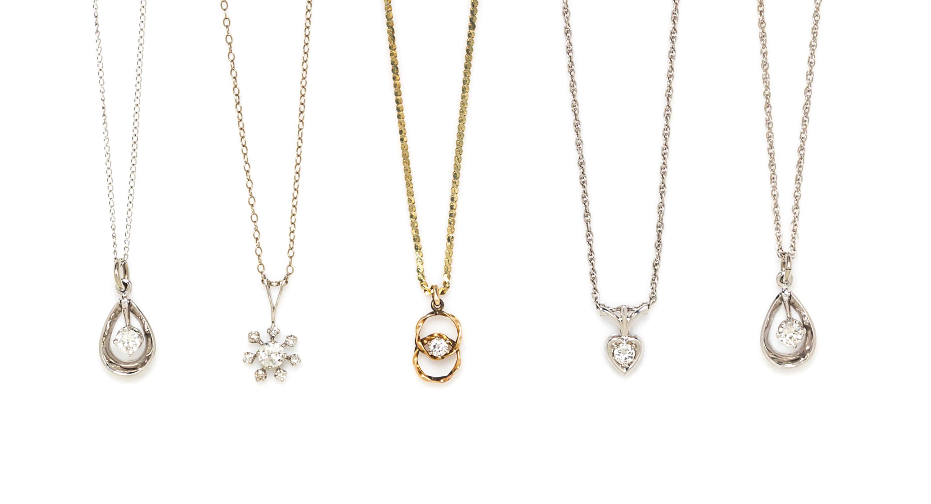 A Collection of Gold and Diamond Pendants, 8.80 dwts.