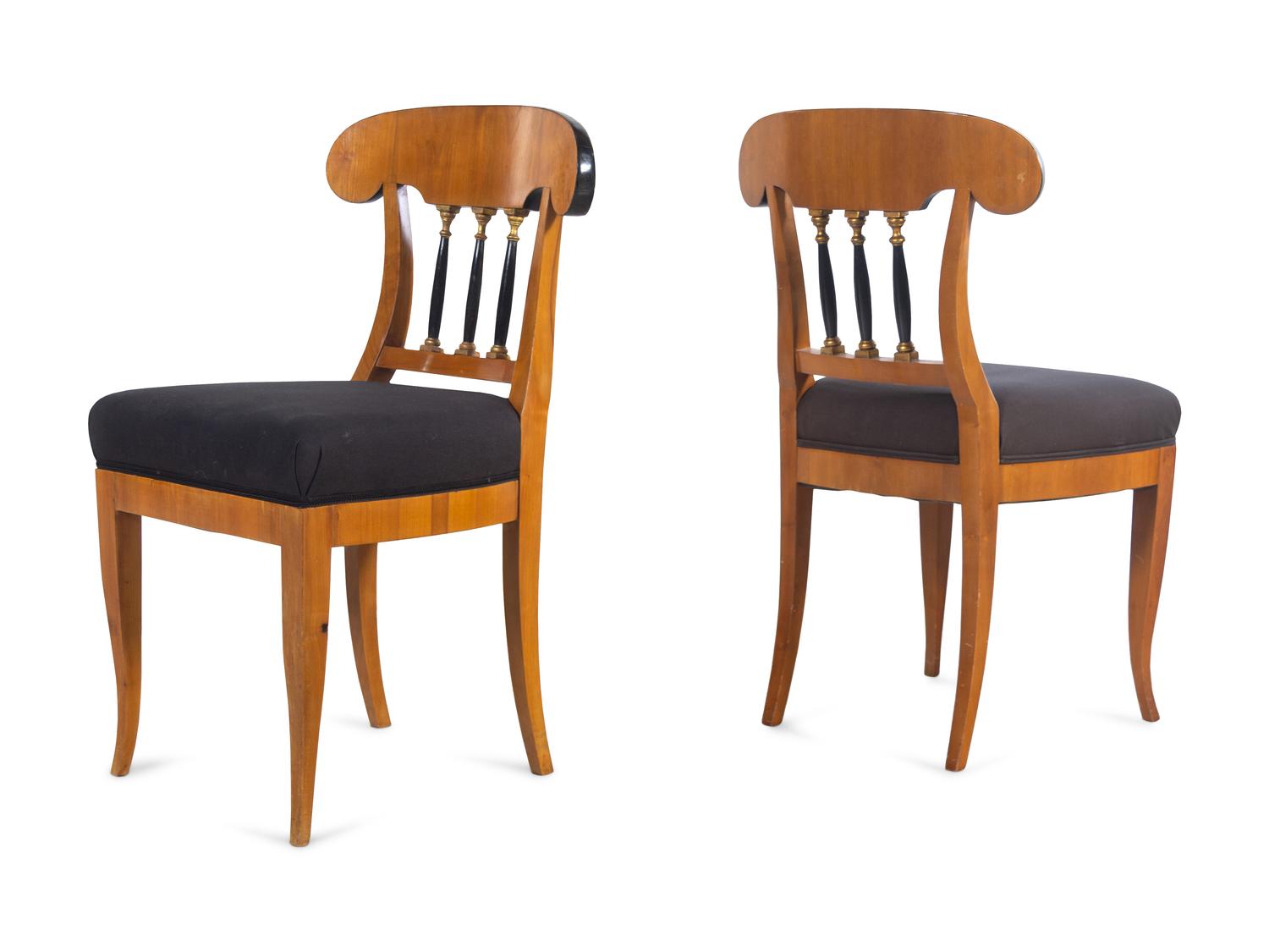 A Set of Eight Biedermeier Style Parcel Ebonized Dining Chairs