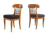 A Set of Eight Biedermeier Style Parcel Ebonized Dining Chairs