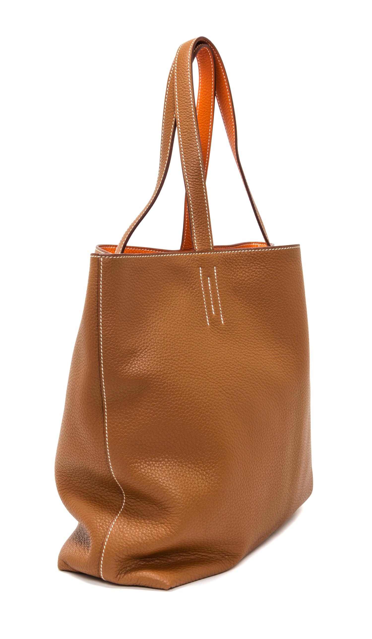 An Hermes Orange/Gold 45cm Taurillon Clemence Double Sens Tote, 17.5" x 15.5" x 5".