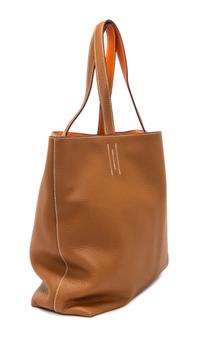 An Hermes Orange/Gold 45cm Taurillon Clemence Double Sens Tote, 17.5" x 15.5" x 5".
