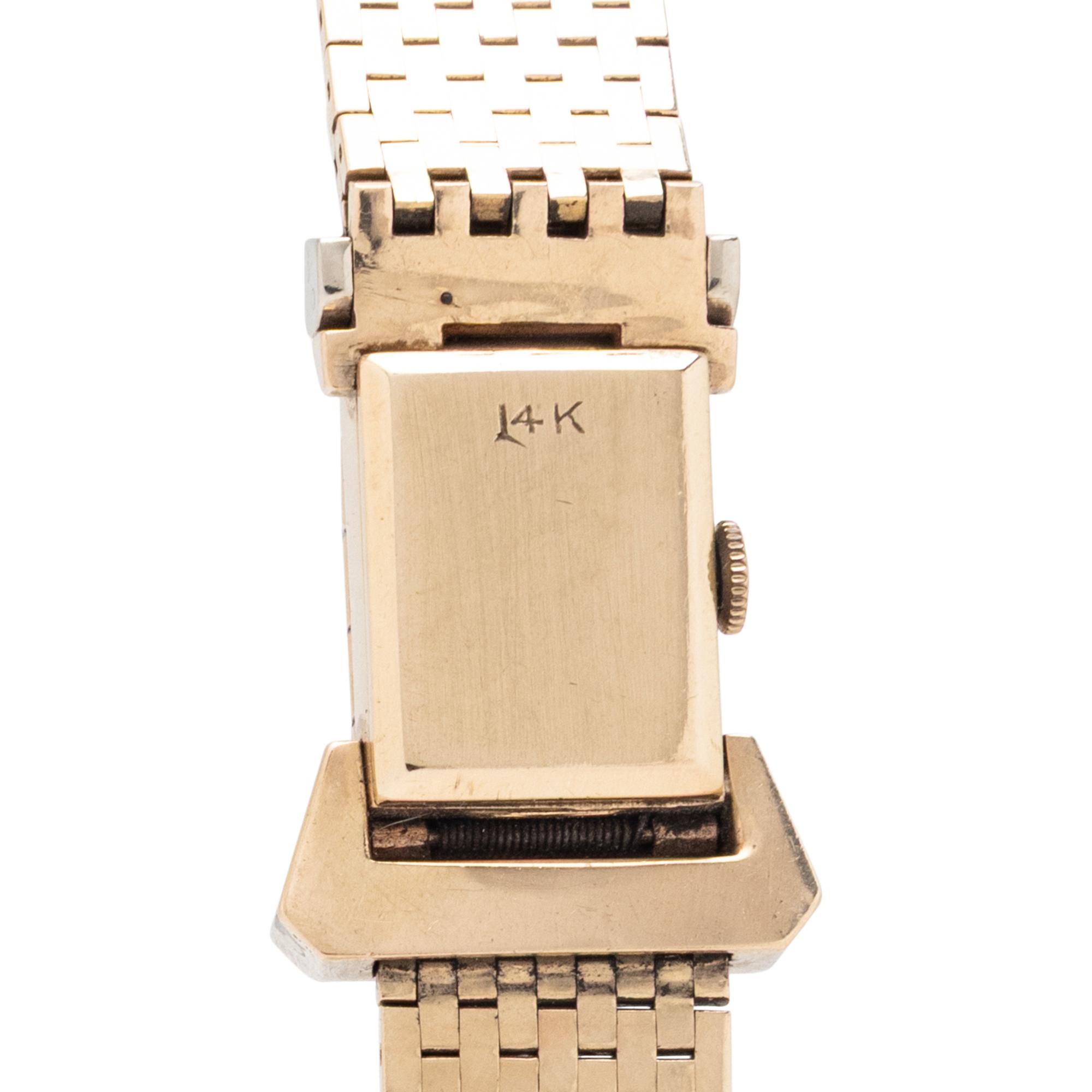 GENOVA, 14K YELLOW GOLD SURPRISE WATCH WITH RUBIES AND DIAMONDS