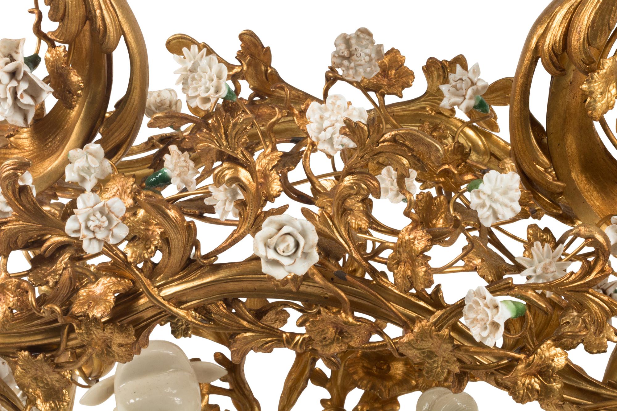 A Louis XV Style Porcelain Mounted Gilt Bronze Clock
