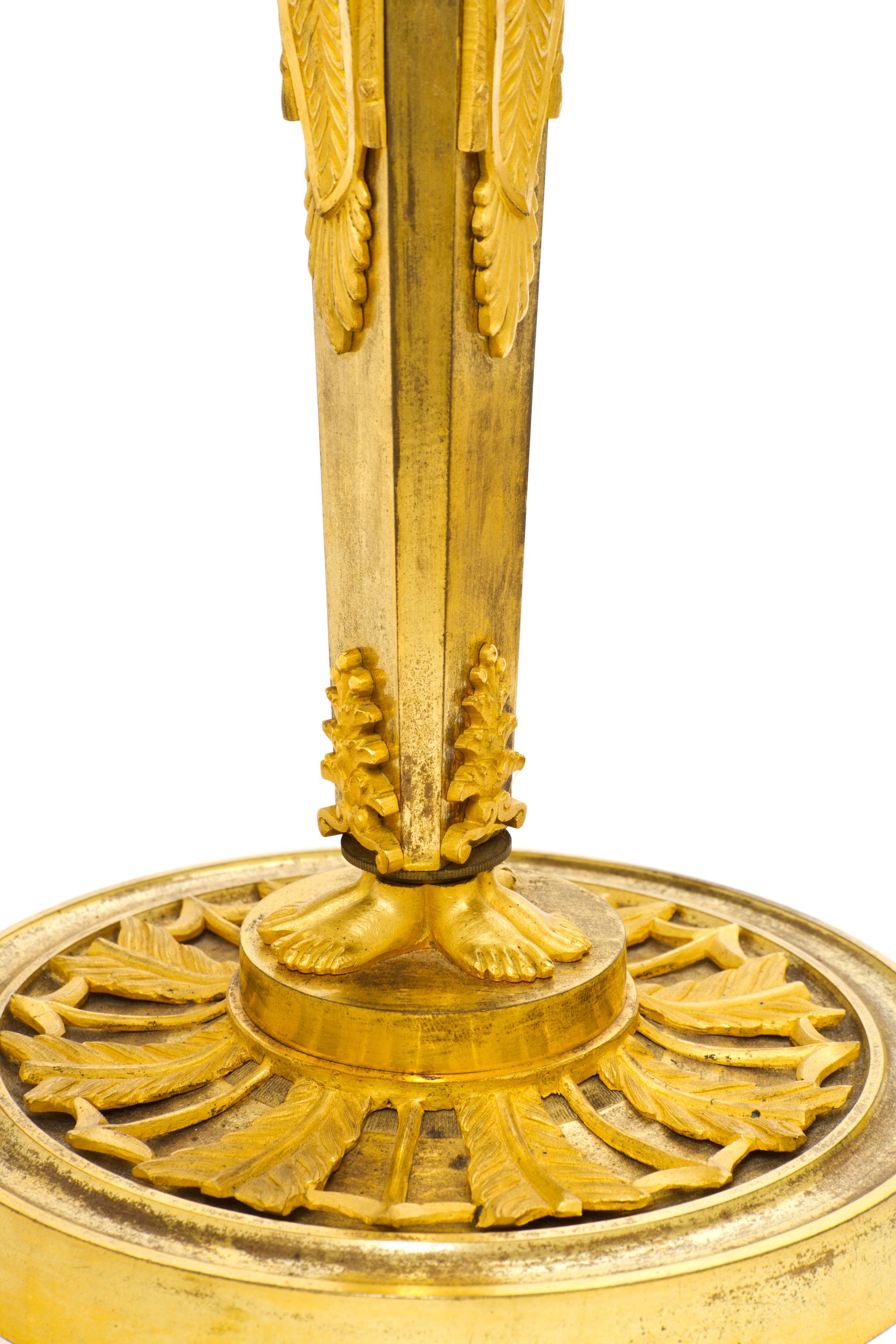 A Pair of Empire Gilt Bronze Candlesticks, EARLY 19TH CENTURY, Height 13 3/4 inches. — EARLY 19TH CENTURY,