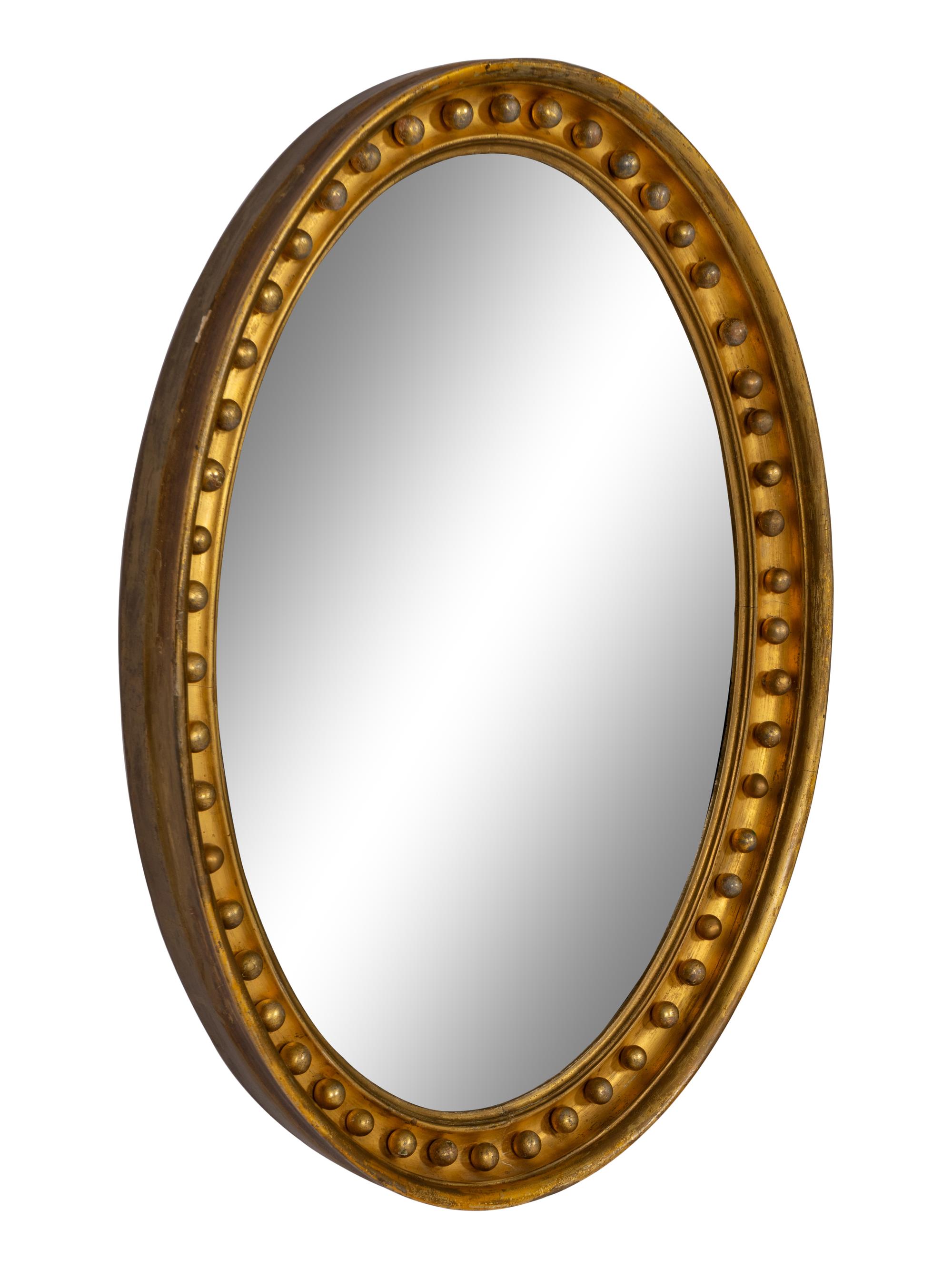 A Regency Style Oval Giltwood Mirror