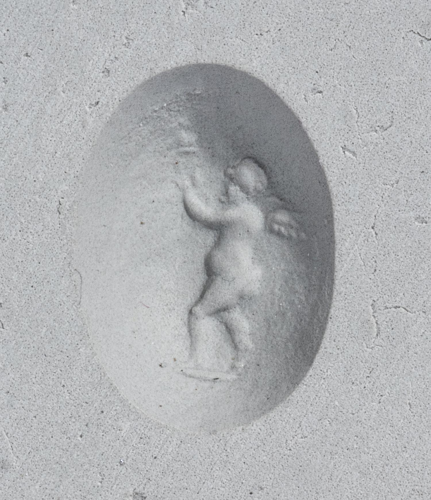 A Roman Banded Agate Ring Stone with the Infant Eros Holding a Butterfly — Set in a silver ring