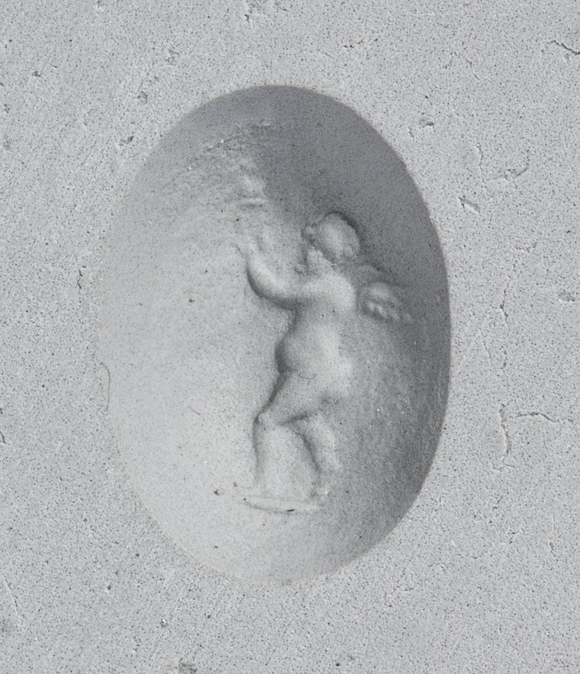 A Roman Banded Agate Ring Stone with the Infant Eros Holding a Butterfly — Set in a silver ring